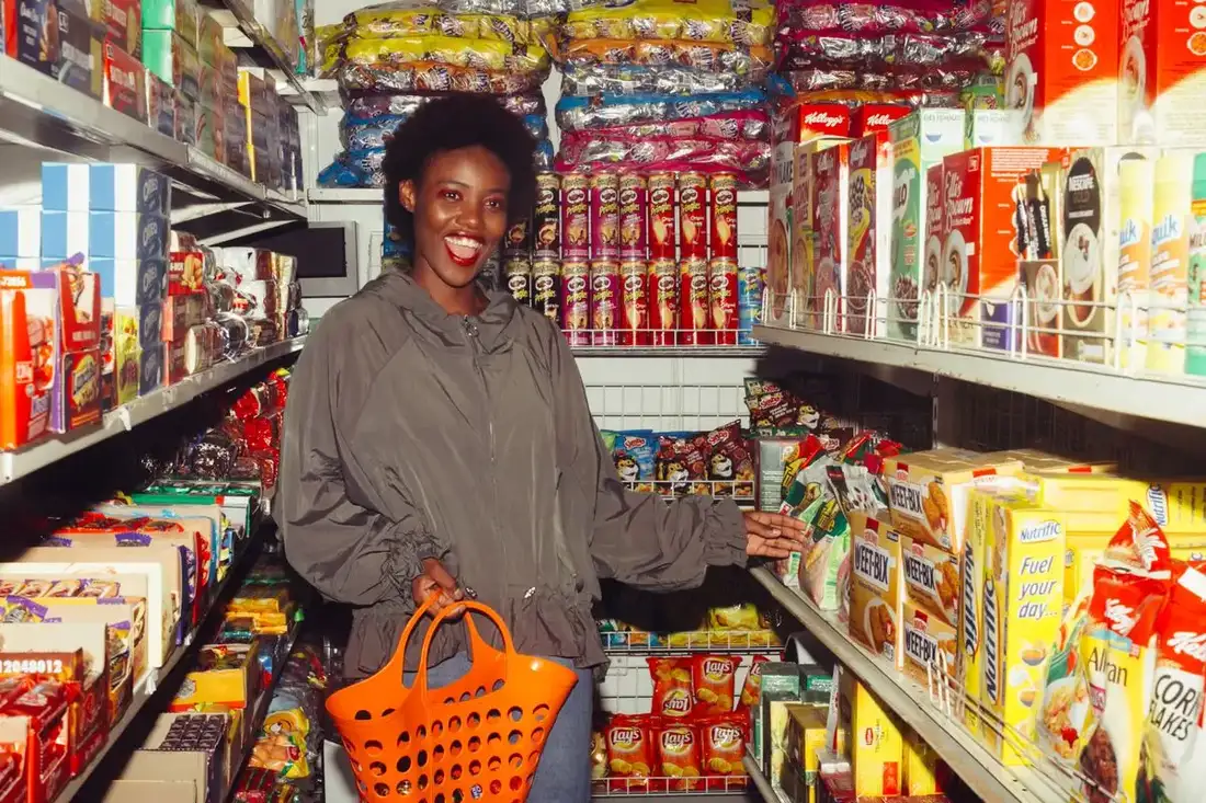 Shopper smiling in a store after covering an everyday expense